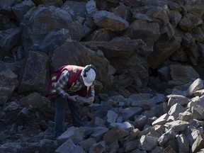 A worker inspects graphite ore at the Nouveau Monde Graphite Matawinie Mine in Saint-Michel-des-Saints, Quebec, Canada, on Oct. 6, 2022.