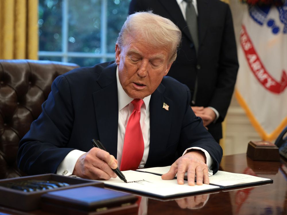 Donald Trump signs an executive order in the Oval Office at the White House, directing the Commerce Department to open an investigation into potential tariffs for copper imports.