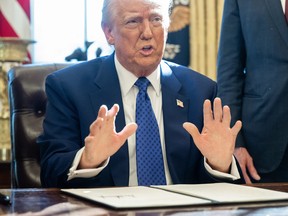 United States President Donald Trump speaks after signing an executive order in the Oval Office of the White House in Washington, D.C.
