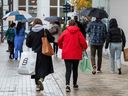 Shoppers carry bags in Walnut Creek, Calif. The headline CPI increased three per cent in January from a year ago, up from 2.9 per cent the previous month.