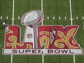 Philadelphia Eagles players warm up before the NFL Super Bowl 59 football game against the Kansas City Chiefs, Sunday, Feb. 9, 2025, in New Orleans.