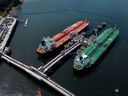 Crude oil tankers SFL Sabine, back left, and Tarbet Spirit are seen docked at the Trans Mountain Westridge Marine Terminal, where crude oil from the expanded Trans Mountain pipeline is loaded onto tankers, in Burnaby, B.C.