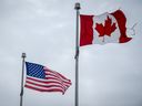 The Canadian and US flags fly near the Canada-US border in Blackpool, Quebec, Canada.