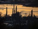 A boat travels past the Parkland Burnaby Refinery on Burrard Inlet at sunset in Burnaby, B.C., Saturday, April 17, 2021.