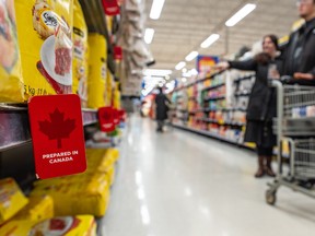 Customers grocery shopping in an aisle at the Real Canadian Superstore on March 3, 2025 in Toronto.