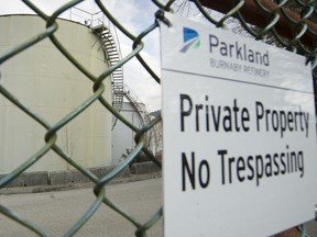 Some of many giant storage tanks seen through the fence of the Parkland refinery site in North Burnaby.