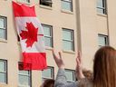 Members of the NDP caucus flew the Canadian flag on March 25, 2025 in an office outside the Alberta Legislature outside Edmonton.