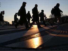WASHINGTON, DC - JANUARY 07: Commuters brave the frigid temperature as they cross the street on Capitol Hill, January 7, 2014 in Washington, DC. A polar vortex that has swept into the east coast bringing with it dangerously cold temperatures not seen in the area in about 20 years.