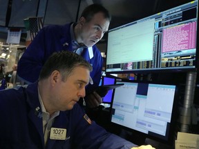 Traders work on the floor of the New York Stock Exchange