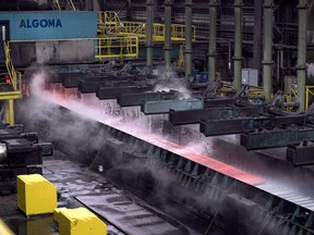 Steam rises as water is poured over hot steel at the Direct Strip Production Complex at Essar Steel Algoma in Sault Ste. Marie, Ont., on Wednesday, March 14, 2018.
