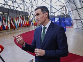 Spain's Prime Minister Pedro Sanchez speaks with the media as he arrives for an EU Summit at the European Council building in Brussels, Thursday, March 6, 2025.