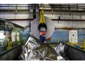 Seorang pekerja memandu hoist karena menurunkan gulungan aluminium ke platform penyimpanan di Sayanal Foil Mill, yang dioperasikan oleh United Co. Rusal, di Sayanogorsk, Rusia, pada hari Rabu, 26 Mei 2021. United Co. Rusal PJSC PETOR PERUSAHAAN DENGAN SURASI METOLUK DENGAN METOLUM DENGAN METOLUM DENGAN METOLUM DENGAN KONFORT LERFORT LERFORT PRINT FORMER UNTUK PERUSAHAAN UNTUK PERECAN KALIF UNTUK PERUSAHAAN UNTUK PERUSAHAAN. Fotografer: Andrey Rudakov/Bloomberg