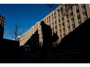 A pedestrian near a General Services Administration (GSA) building in Washington, DC, US, on Monday, Feb. 24, 2025. Elon Musk's demand that more than two million federal employees defend their work is facing pushback from other powerful figures in the Trump administration, in a sign that the billionaire's brash approach to overhauling the government is creating division. Photographer: Al Drago/Bloomberg