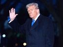 President Donald Trump waves to the media as he walks on South Lawn of the White House, in Washington, Sunday, March 9, 2025.