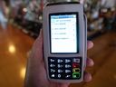 A payment terminal displays tip options at a restaurant in Montreal, Que.