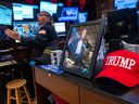 A picture of U.S. President Donald Trump is displayed as traders work on the New York Stock Exchange floor in New York City.