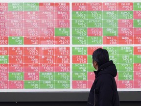 FILE - A person looks at an electronic stock board showing Japan's Nikkei index at a securities firm in Tokyo, on Jan. 28, 2025.