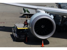 A mechanic works connected the motor of an Air Canada airplane astatine Vancouver International Airport (YVR) successful Vancouver, British Columbia, Canada, connected Thursday, July 11, 2024. The broadening of the disinflation process stalled retired successful June with prices successful the discretionary services categories, specified arsenic restaurants, hotels, and aerial travel, each increasing.