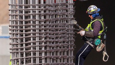 A construction worker assembles steel rebar