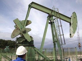 A production manager for Canadian based Vermilion oil company, watches an oil rig on Sept. 6, 2017 in Andrezel, south east of Paris.