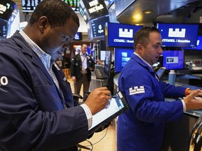 Trader Thomas Lee, left, and specialist Genarro Saporito work on the floor of the New York Stock Exchange, Thursday, May 8, 2025.