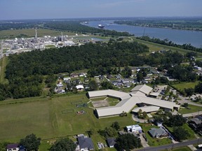 FILE - The Fifth Ward Elementary School and residential neighborhoods sit near the Denka Performance Elastomer Plant, back left, in Reserve, La., Sept. 23, 2022.