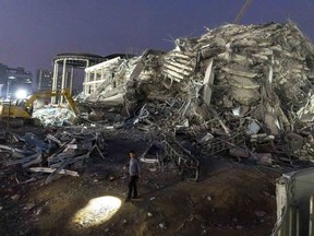 FILE- Rescuers search for victims at the site of a high-rise building under construction that collapsed after a strong earthquake in Bangkok, Thailand, early Saturday, March 29, 2025.