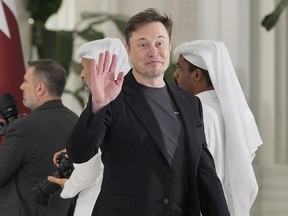 Elon Musk gestures as he arrives for a state dinner hosted by Qatar's Emir Sheikh Tamim bin Hamad Al Thani in honor of President Donald Trump at Lusail Palace in Doha, Qatar, Wednesday, May 14, 2025.