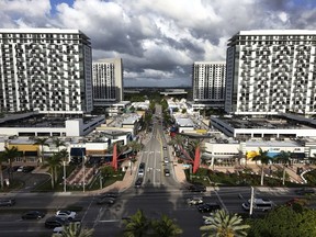FILE - Cars pass through the area known as Downtown Doral, April 5, 2025, in Doral, Fla.