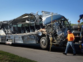 FILE - A damaged Greyhound bus is prepared for transport on Wednesday, July 12, 2023, from the scene of a fatal wreck on westbound Interstate 70 after the bus collided with a tractor-trailer near Highland, Ill.
