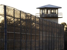 FILE - The sun sets behind Holman Prison in Atmore, Ala., Jan., 27, 2022.