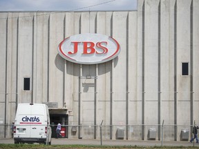 FILE - In this Friday, July 223, 2021, photograph, employees move into an entrance to the JBS meat processing plant in Greeley, Colo.