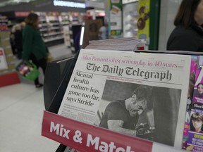 FILE -The Daily Telegraph newspaper with the front page of French President Emanuel Macron is seen at a supermarket in London, March 21, 2024.