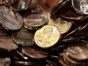 FILE - Freshly-made pennies sit in a bin at the U.S. Mint in Denver on Aug. 15, 2007.