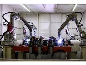 Robotic arms operate at a Linamar Corp. of Canada EV battery case manufacturing facility.