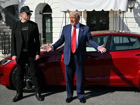 U.S. President Donald Trump and Tesla CEO Elon Musk speak to the press as they stand next to a Tesla vehicle on the South Portico of the White House on March 11, 2025 in Washington, D.C.