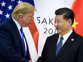 In this file photo taken on June 28, 2019, China's President Xi Jinping (R) shakes hands with U.S. President Donald Trump before a bilateral meeting on the sidelines of the G20 Summit in Osaka.