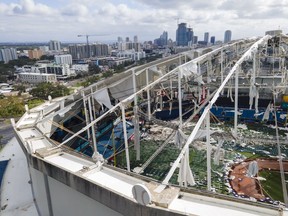 FILE - The roof of the Tropicana Field is damaged the morning after Hurricane Milton hit the region Oct. 10, 2024, in St. Petersburg, Fla.