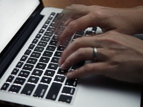 FILE - This June 19, 2017 file photo shows a person working on a laptop in North Andover, Mass.