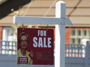 FILE - A for sale sign stands outside a residence in Niles, Ill., Monday, July 1, 2024.