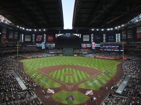 FILE - The roof to Chase Field begins to open prior to an opening-day baseball game between the Arizona Diamondbacks and the Chicago Cubs, March 27, 2025, in Phoenix.
