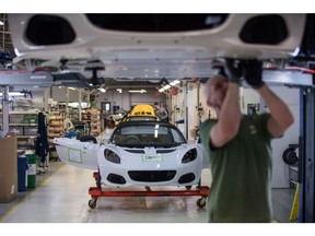 An employee works on the underside of a Lotus Elise sports coupe automobile as it moves down the production line at the Group Lotus Plc, a luxury unit of Proton Holdings Bhd., automobile factory in Hethel, U.K., on Thursday, Aug. 10, 2017. Lotus is about to be rescued by the same Chinese billionaire who bought Volvo Cars, just in time to help it maneuver the challenge of trading after Brexit.