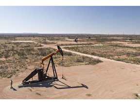 Pumpjacks operate on oil wells in the Permian Basin in Crane, Texas.