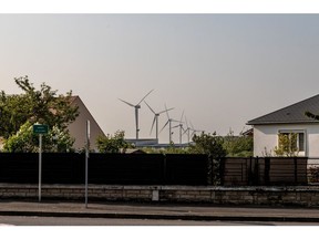 Wind turbines beyond housing in Sermaises, France, on Tuesday, May 3, 2022. Electricite de France SA's (EDF) falling nuclear production, combined with Russia's invasion of Ukraine, is exacerbating Europe's energy crisis as France is traditionally a net exporter of electricity.