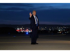 Donald Trump waves after leaving the G7 Leaders' Summit early on June 16.