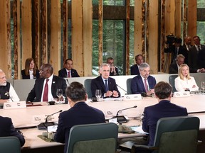 Prime Minister Mark Carney, centre, presides over a working lunch alongside world leaders and outreach representatives during the Group of Seven Summit at the Kananaskis Country Golf Course in Kananaskis, Alta., on June 17.