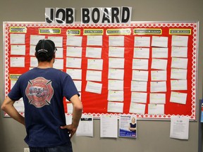 A man looks over a job board in the Employment Resource Centre in the Bayside Mall in Sarnia, Ont.