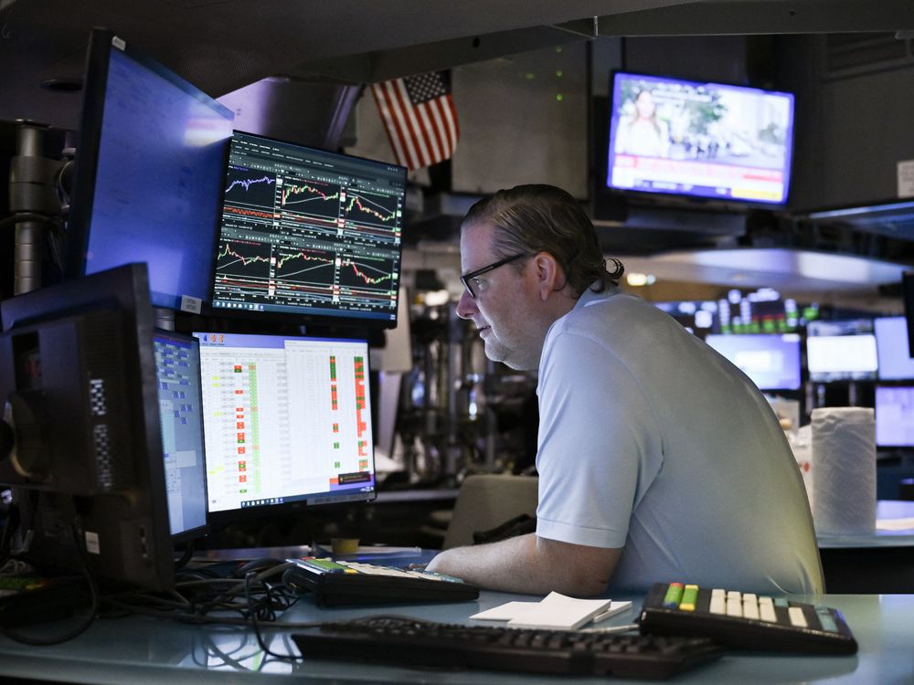 Traders work on the floor of the New York Stock Exchange in New York City.