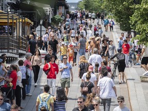 Pedestrians walk in Place Jacques-Cartier in Old Montreal, Que.