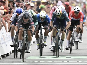 Alpecin-Deceuninck team's Belgian rider, Jasper Philipsen, second left, sprints to the finish line to win the 10th stage of the 111th edition of the Tour de France cycling race between Orleans and Saint-Amand-Montrond, central France, on July 9, 2024.